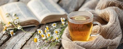 A Tranquil Tea Background Featuring A Cup Of Chamomile Tea On A Wooden