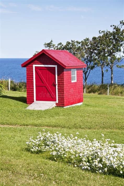 red shed stock photo image  water building garden
