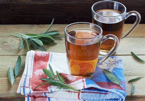 Sage Herbal Tea Or Decoction In Two Glass Cups With Herb Leaves Stock