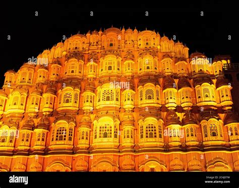 Jaipur, Rajasthan, India; Feb, 2020 : silhouette of tourists in front of the Hawa Mahal at night ...