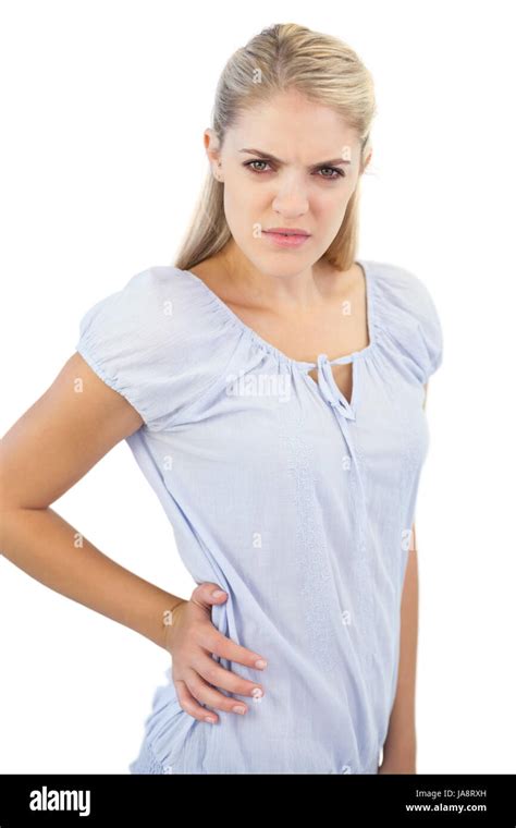 Unsmiling Blonde Woman Has Pain In Lower Back On White Background Stock
