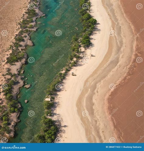 Aerial View Of A Pink Sand Beach And Red Dirt Road Next To Roebuck Bay