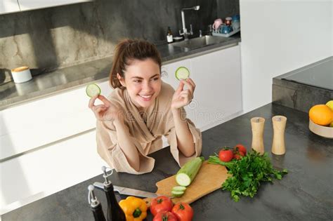 Portrait Of Beautiful Brunette Girl Chopping Vegetables For Meal