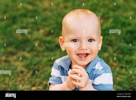 Outdoor Portrait Of Adorable Laughing Baby Boy Playing In Summer Parc