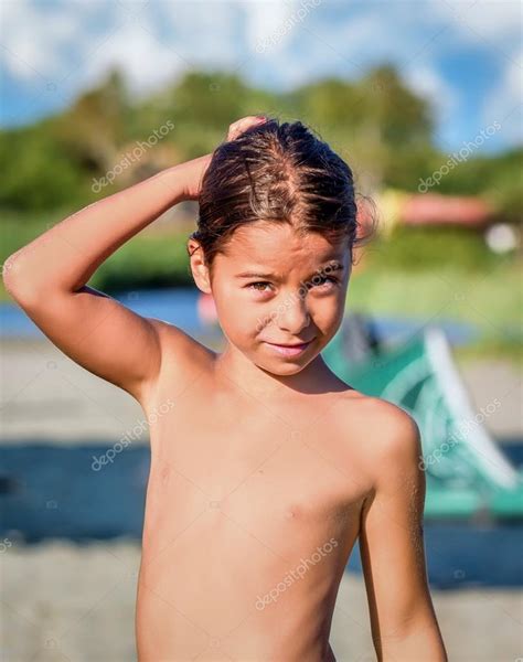 Beautiful Eight Year Old Girl Smiling On The Beach Stock Photo By