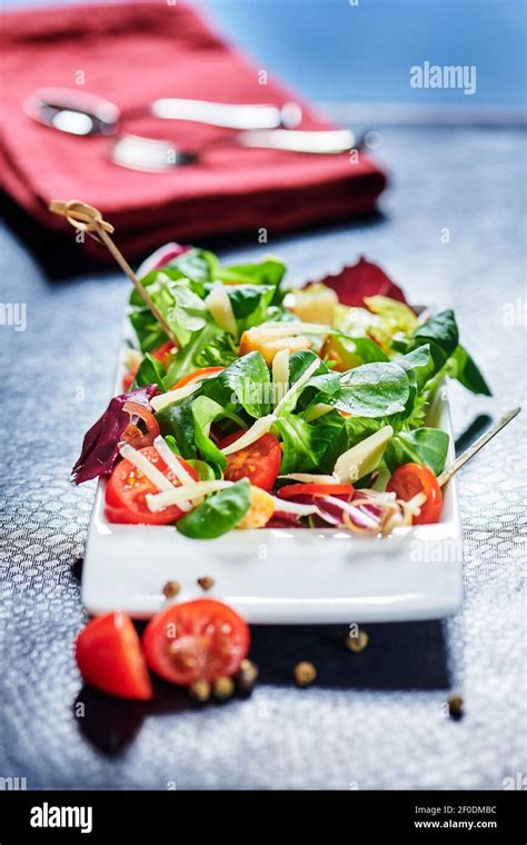 Fresh Mixed Salad With Endive And Cherry Tomatoes On Black Plate Dining