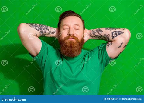 Photo Of Dreamy Positive Man Wear T Shirt Closed Eyes Arms Behind Eyes