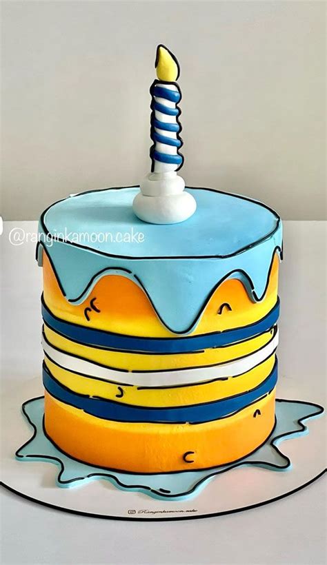 A Blue And Yellow Cake With A Candle On Top