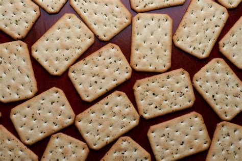 Premium Photo A Tray Of Crackers With A Few Flaky Flaky Crust