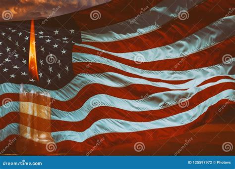 Light Candle Burning Brightly In The American Flag Background Stock