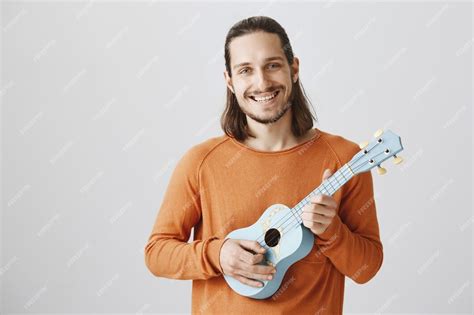 Free Photo Cheerful Smiling Hipster Guy With Ukulele