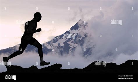 Running Man Athlete Trail Running In Mountain Summit Background Male