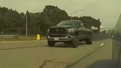 Watch This Coal Rolling Ram Go Crazy When A Tesla Is Spotted