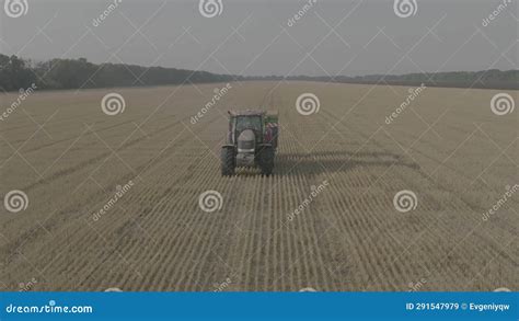 Farmer On Tractor Fertilizing Agricultural Field Spreading Mineral