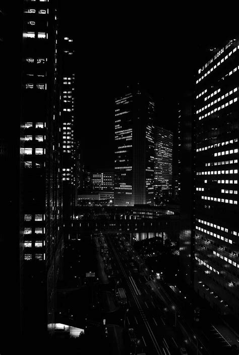 Black And White Photo Of City At Night With Lights In The Windows Cars