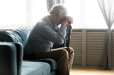 Premium Photo Depressed Unhappy Old Man Sit On Couch At Home Hold