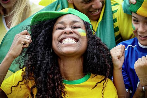 Brazilian football fans cheering at match - Stock Photo - Dissolve