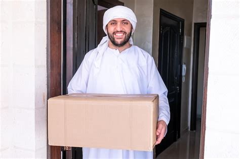 Premium Photo Arabic Man Holding Box Of Cartoon