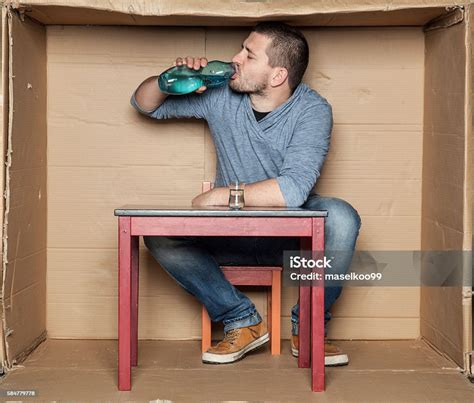 Homeless Man Drinking Alcohol From A Bottle Stock Photo Download