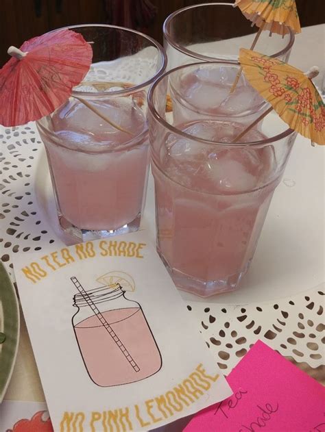 Two Glasses Filled With Pink Lemonade Sitting On Top Of A Doily Covered