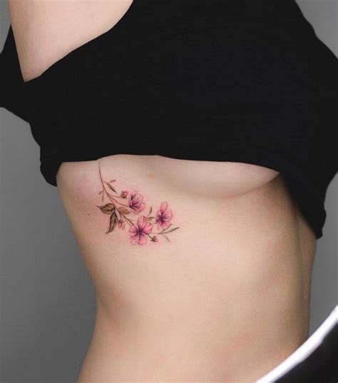 A Woman S Stomach With Pink Flowers On It