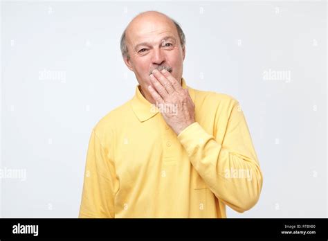 Mature Bald Man Covering Mouth And Laughing Fun Concept Stock Photo