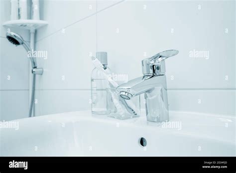 Toothbrush On The Sink In The Bathroom Stock Photo Alamy