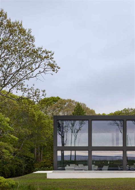 A Grid Of Large Windows Maximizes The Water Views At This Modern Home