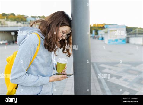 Smart Focused Girl Is Distracted By Mobile Phone Girl Reading