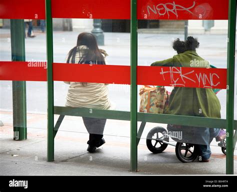 Two Women Waiting For Bus Stock Photo Alamy