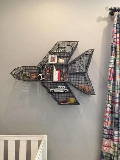 an airplane shaped shelf is hanging on the wall