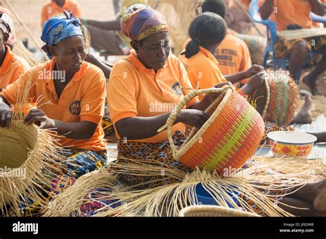 Women From A Weavers Cooperative Weave Traditional Straw Baskets