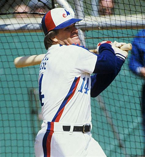 A Baseball Player Holding A Bat On Top Of A Field