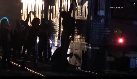 Chaos unfolds in downtown L.A. as large mob vandalizes police car