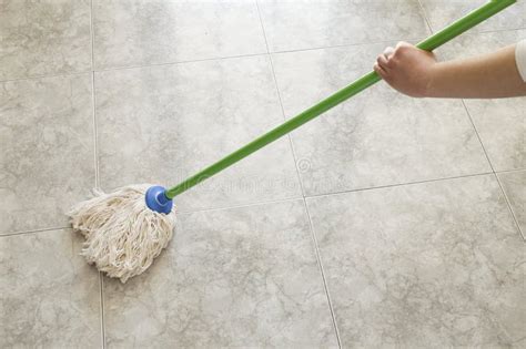 Woman Scrubbing Floor With A Mop Stock Photos - Image: 29868333