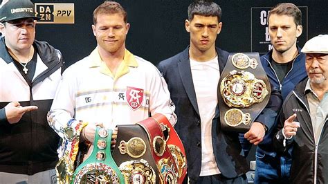 CANELO FLEXES UNDISPUTED BELTS ON DMITRY BIVOL SMILES AS THE TWO SIZE