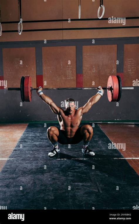 Gym Concept With Strong Man Lifting Barbell Stock Photo Alamy