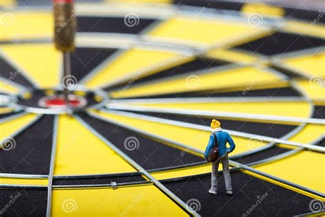 Model Mini People Walks Towards The Target On Dart Board Stock Image