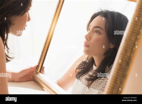 Young Woman Looking Into Mirror Stock Photo Alamy