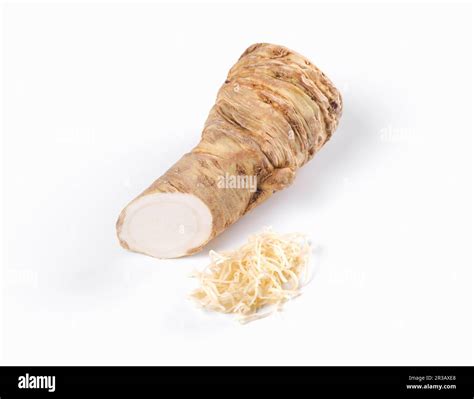 A Piece Of Horseradish Root And Grated Horseradish On A White