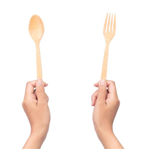 Premium Photo Hand Holding Wood Spoon And Fork Isolated On White