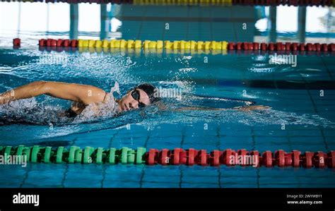 Elite female athlete, professional swimmer during a front crawl swimming workout. Concept of ...