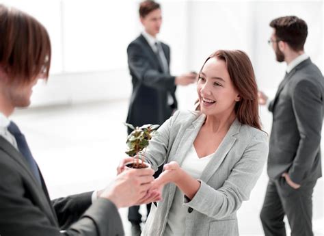 Premium Photo Businessman And Businesswoman Holding A Pot With Sprouts