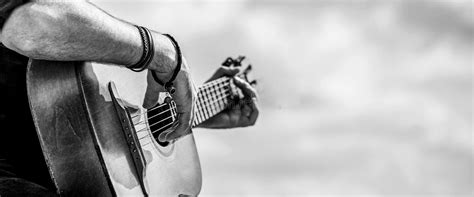 Acoustic Guitars Playing Music Concept Black And White Male Musician Playing Guitar Music