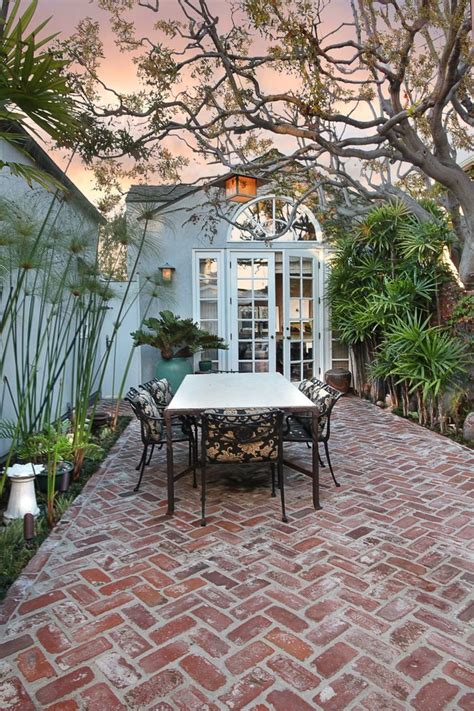 Brick Atrium With Outdoor Dining Table Tree Chandelier Eclectic