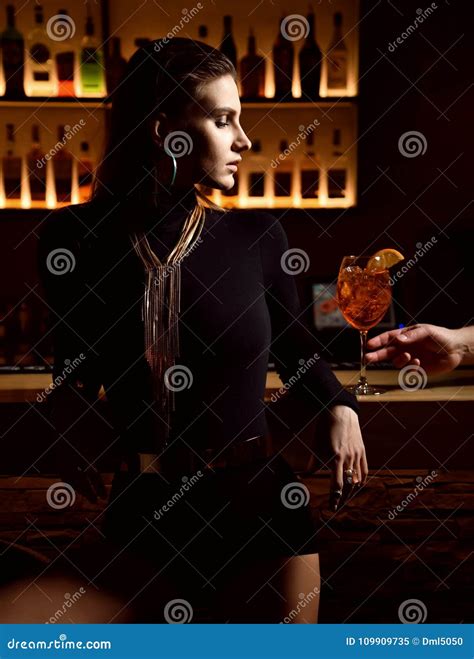 Beautiful Fashion Brunette Woman In Bar Restaurant Relaxing Offer Orange Cocktail Stock Image
