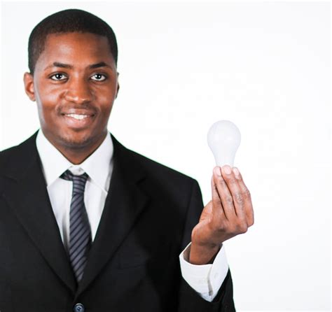 Premium Photo Afro American Businessman Holding A Light Bulb