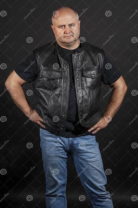 Adult Brutal Bald Man In A Leather Jacket Dark Background Stock Image