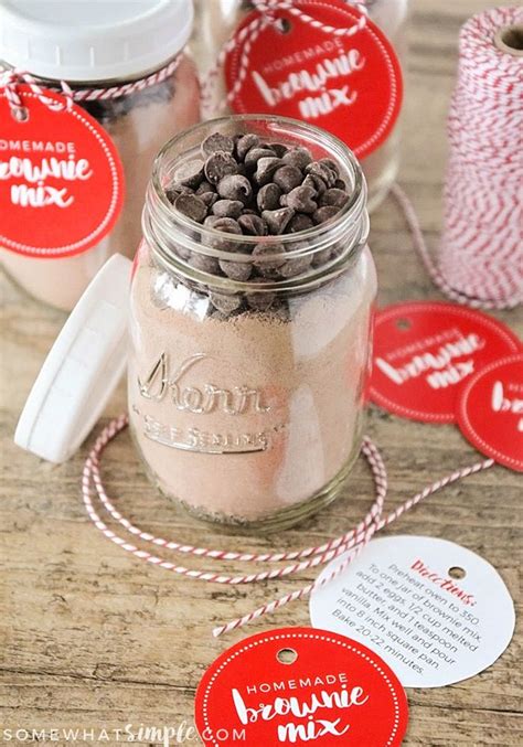 Mason Jar Filled With Chocolate Chip Cookies On Top Of A Wooden Table Next To Red And White Twine