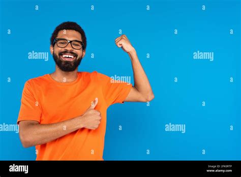 Happy African American Man In Glasses Smiling Showing Muscle And Thumb